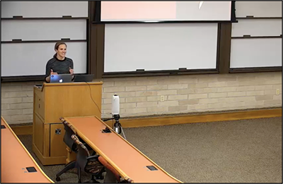 individual speaking at podium