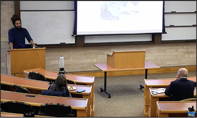 individual speaking at podium in law classroom