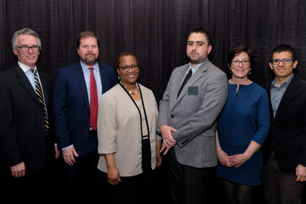 Dean Bruce Smith with law school faculty receive immigration clinic gift