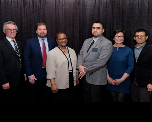 Dean Bruce Smith with law school faculty receive immigration clinic gift